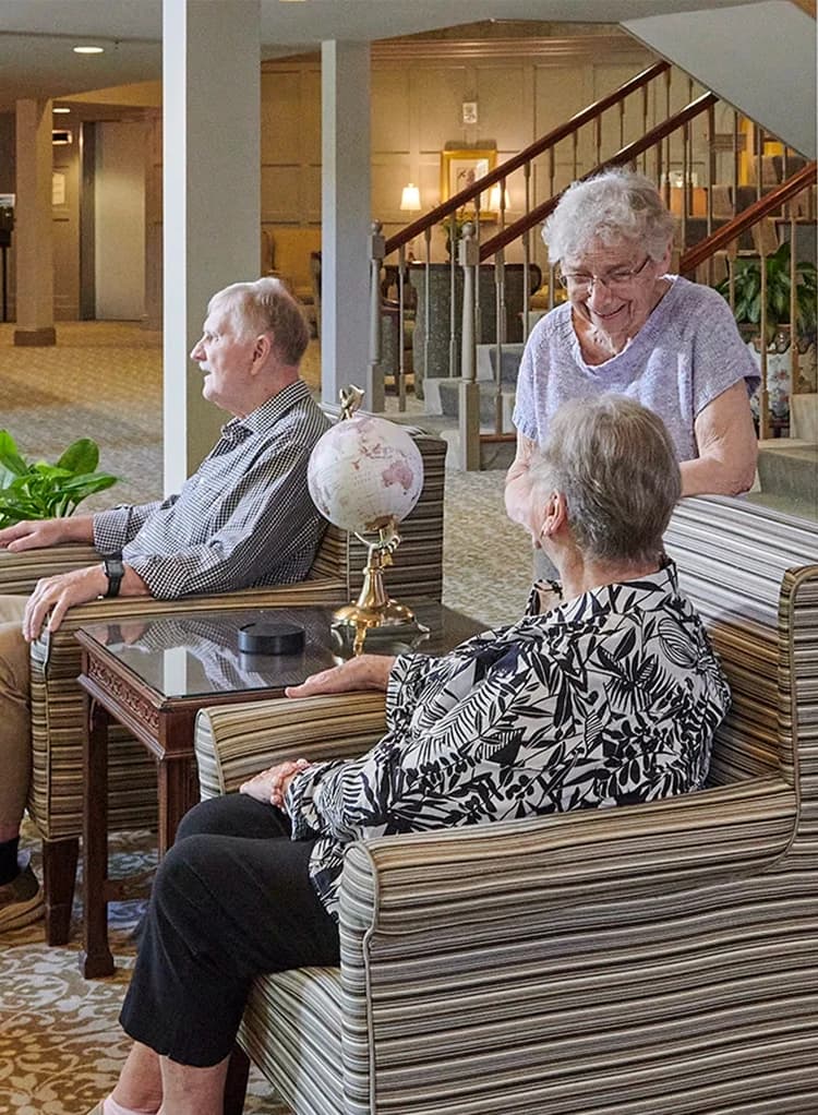 Residents engaged in conversation in large common area