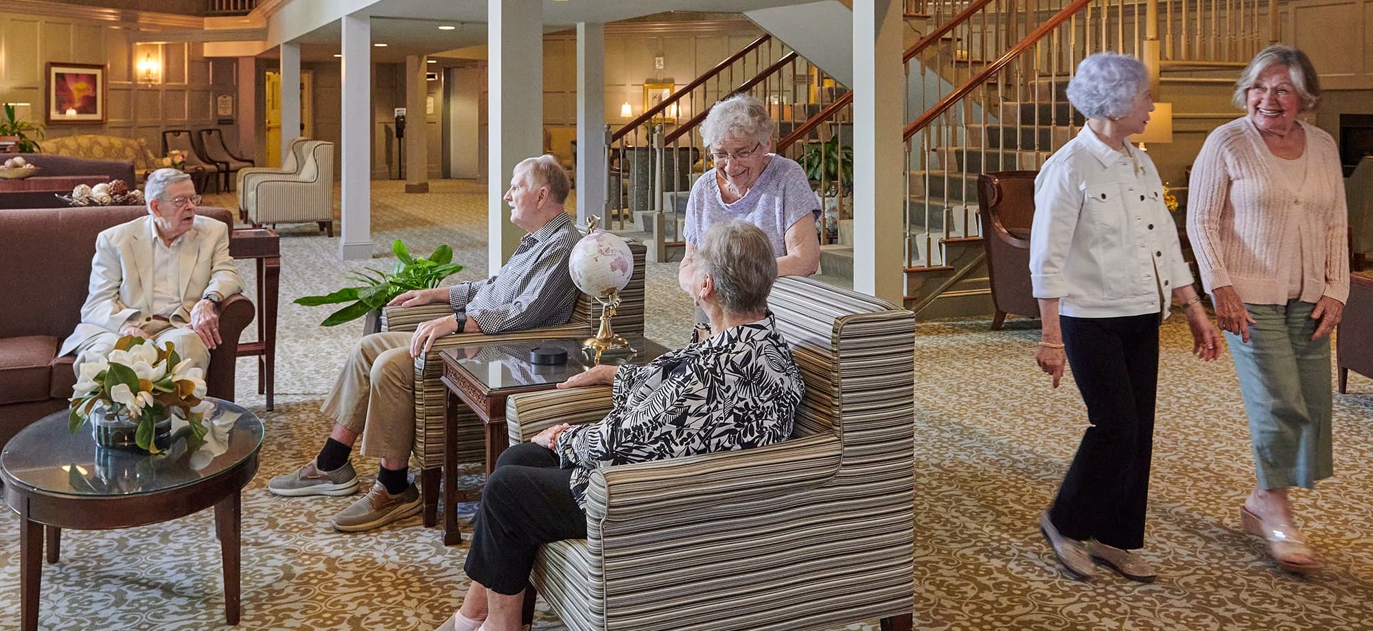 Residents engaged in conversation in large common area