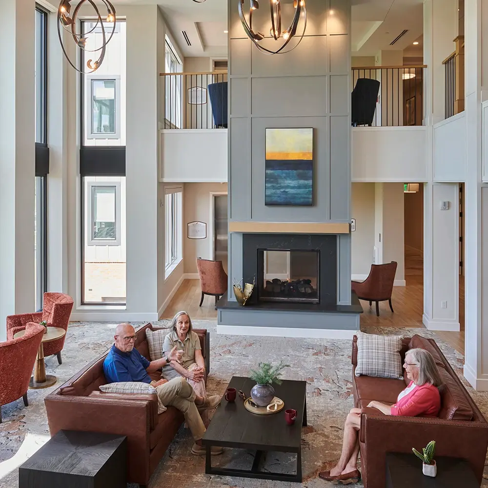 Open modern public area with residents on couches