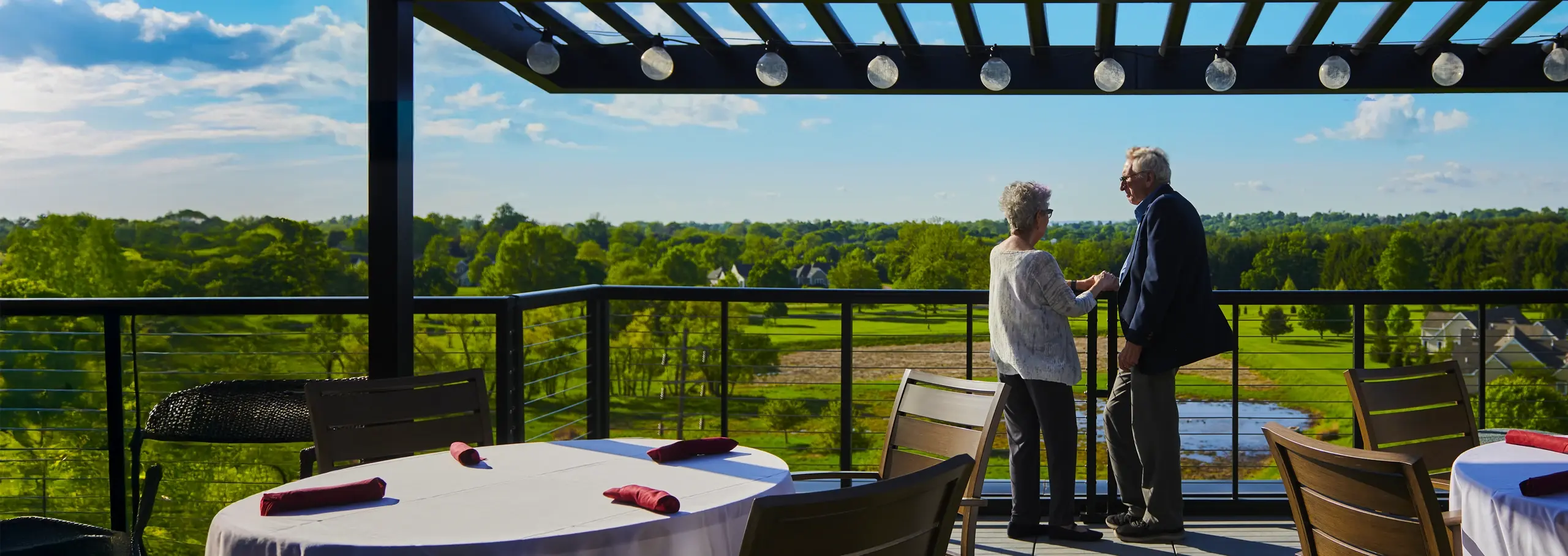 Man and woman on patio with view