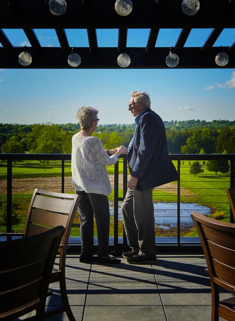 Man and woman on patio with view